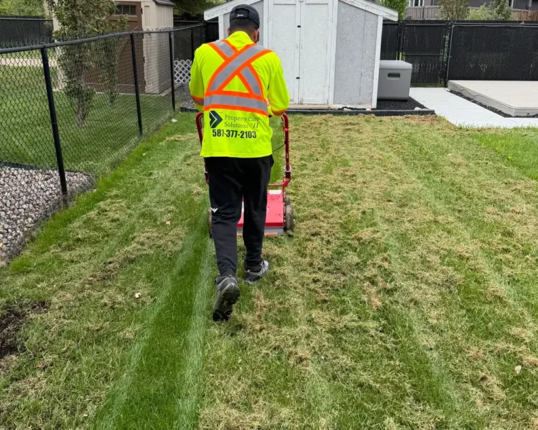 Property Care Solutions professional performing spring clean-up and lawn care service