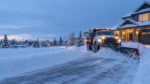 Snow removal crew clearing a driveway in Fort Saskatchewan